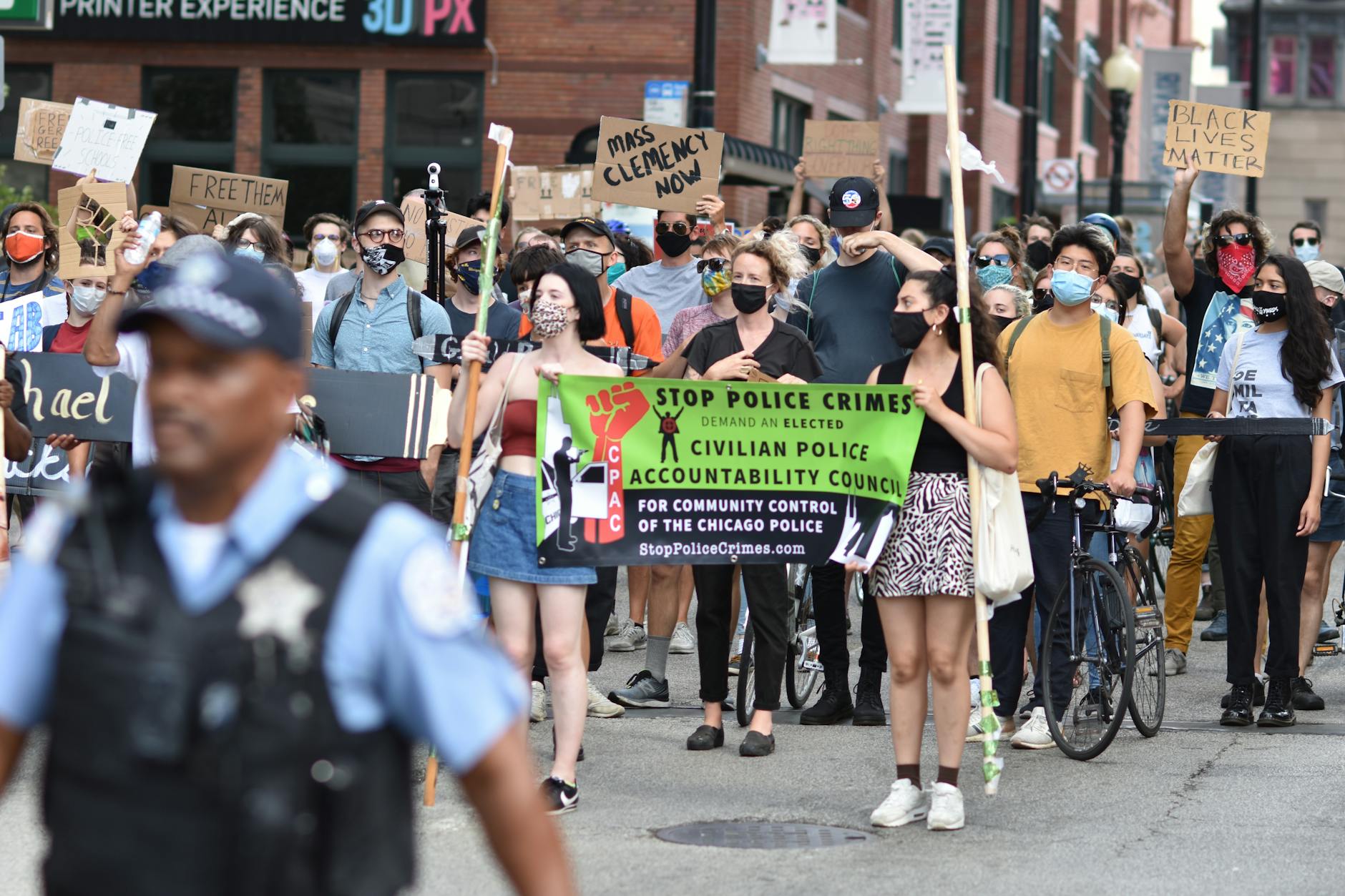 Protesters march in Chicago demanding police accountability. Diverse crowd carries signs for justice.